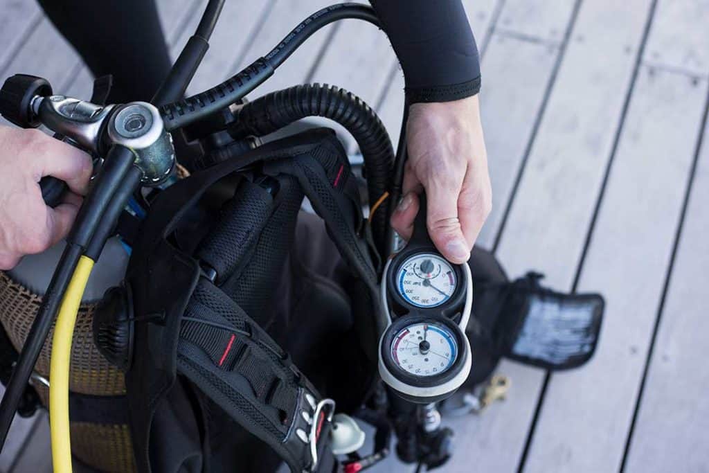 checking tank pressure before a dive