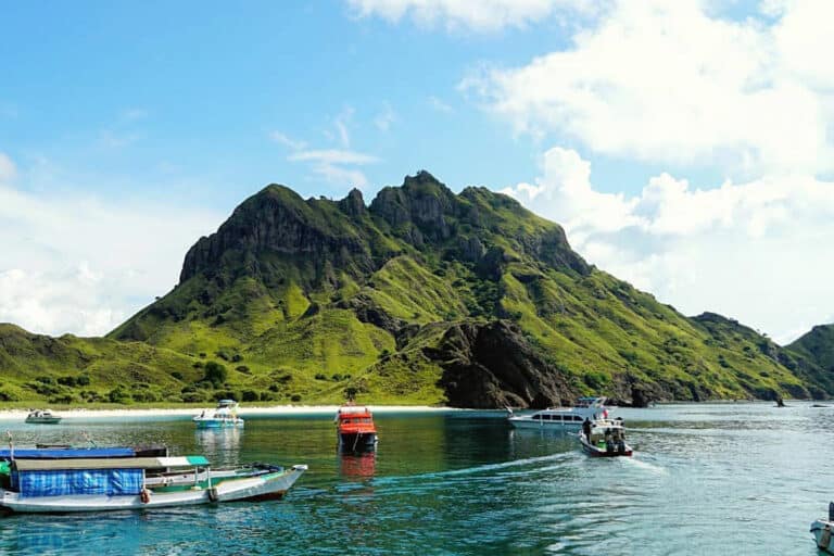dive boat next to an island in komodo park