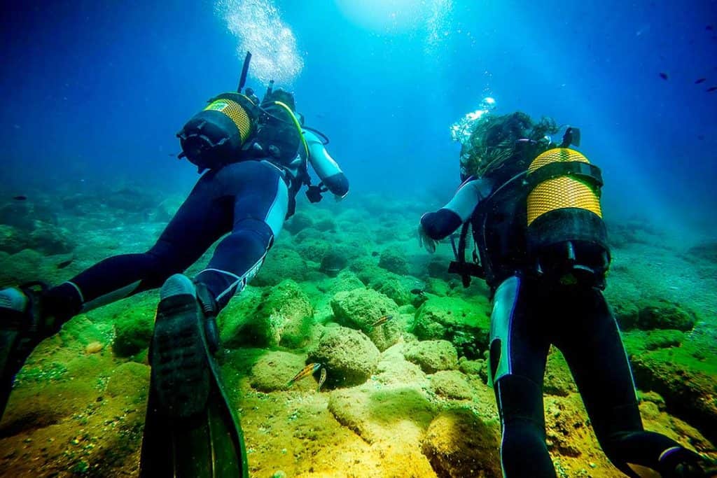 two scuba divers next to each other
