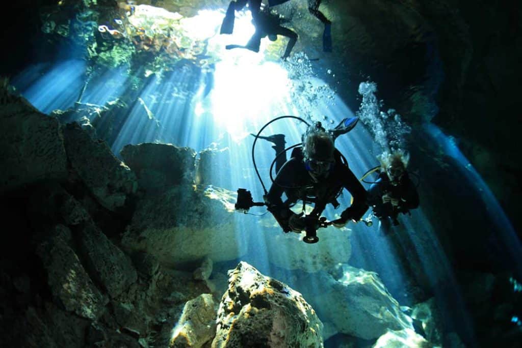 underwater photographers in a cenote